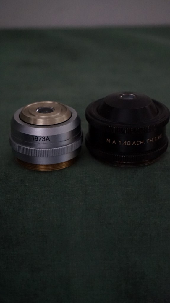 The D.I.Y. condenser based on a # 1973A 1.4 N.A. achromat top lens and housing , left and a Spencer-AO 1.4 N.A. achromat condenser right.