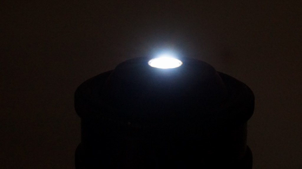 1.4 achromat condenser viewed from the side , while being illuminated from about 7cm. below with an led flashlight.