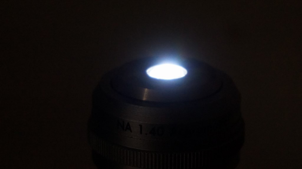 D.I.Y. condenser viewed from the side, while being illuminated from about 7cm. below with an led flashlight.